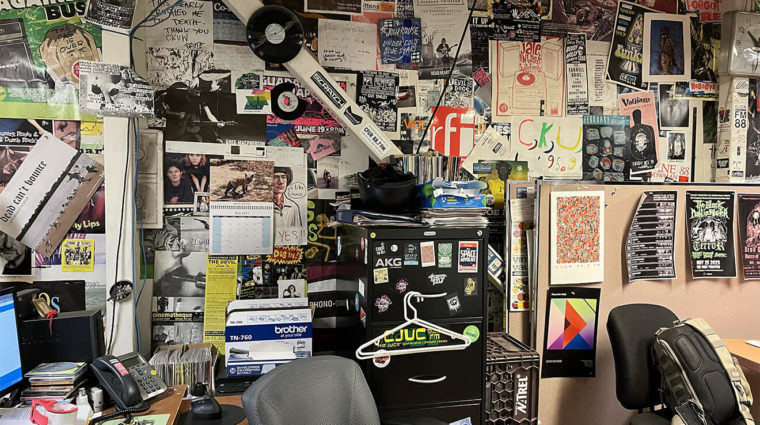 Picture of a wall with many posters for research purposes.