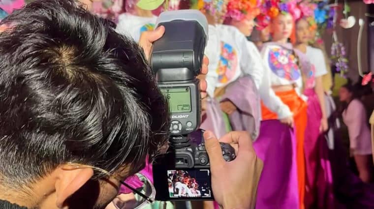 A photo being taken as a photographer snaps models on runways at Fashion Week Toronto 2024