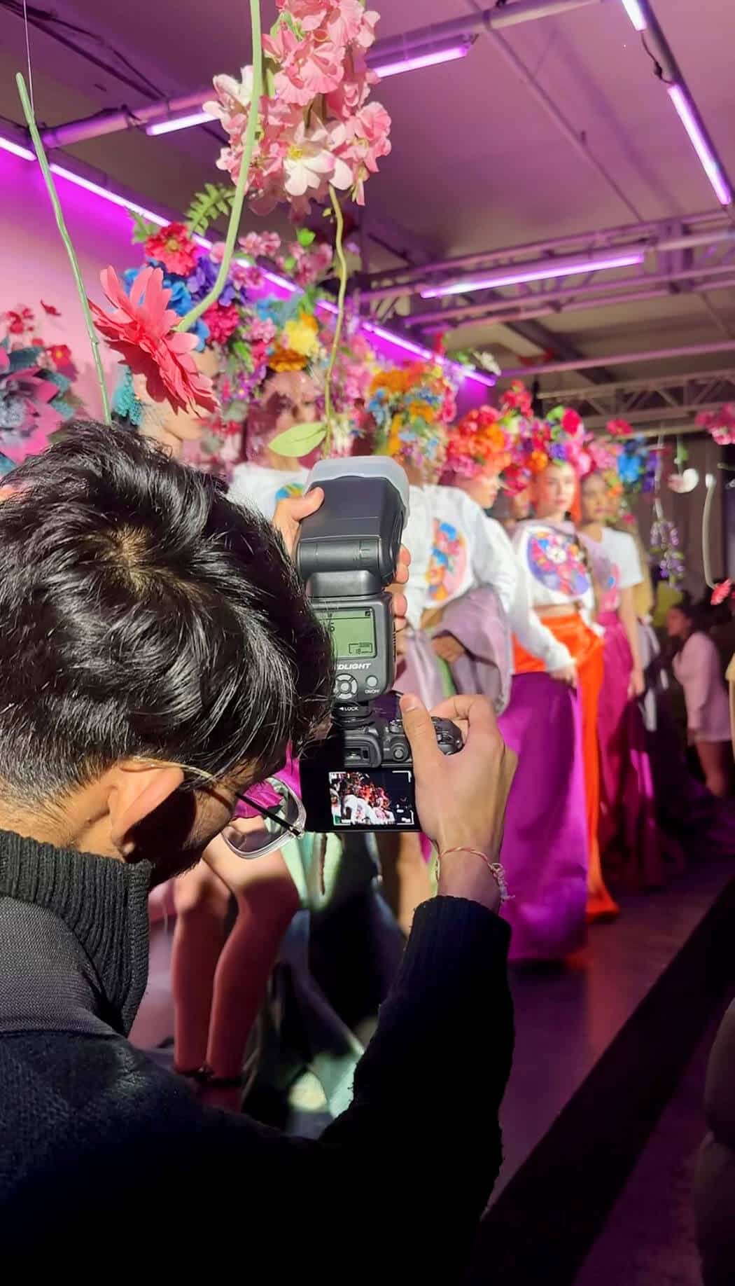 A photo being taken as a photographer snaps models on runways at Fashion Week Toronto 2024