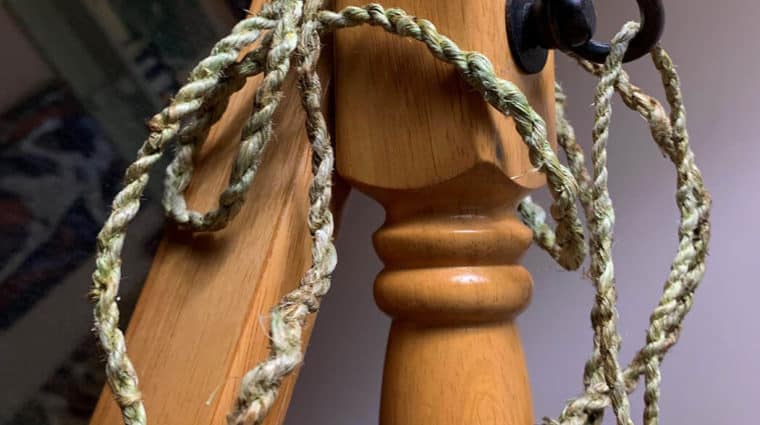 Light green cordage loosely draped over the side of a dressing mirror.