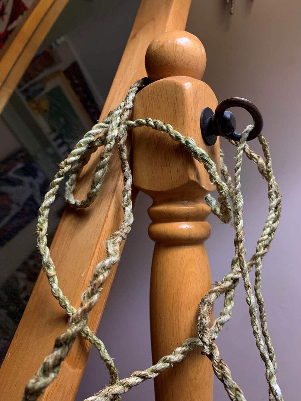 Light green cordage loosely draped over the side of a dressing mirror.