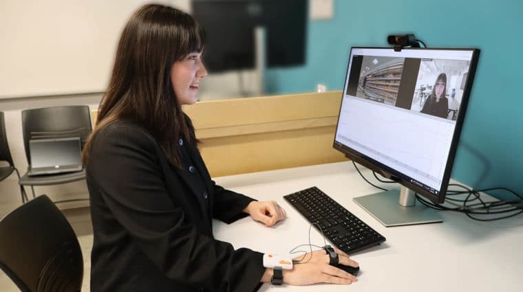 A student looking at a research study on a computer screen with eye-tracking, facial expression, and emotion signals.
